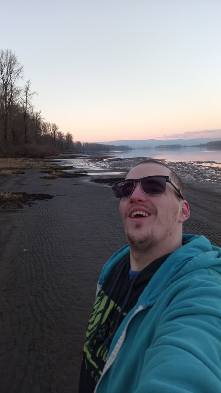 A happy me with the mighty Columbia River heading north, the north end of Sauvie Island, and Washington State blanketed in the sunset in the Background. February 2022
